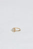 side view of gold ring with elongated rose cut oval diamond and round white diamonds