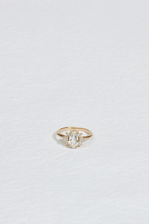 gold ring with elongated rose cut oval diamond and round white diamonds