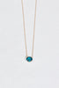gold necklace with oval blue topaz