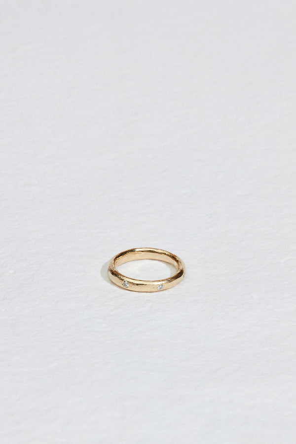 rounded gold band with white diamonds