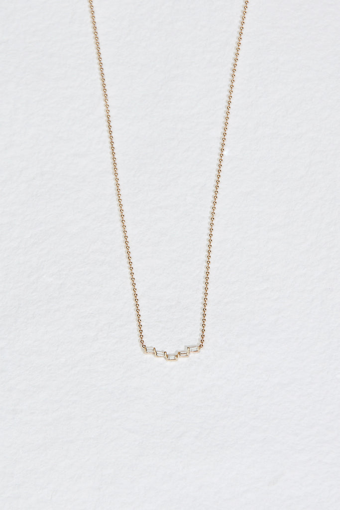 gold ball chain necklace with five baguette cut stair step diamonds
