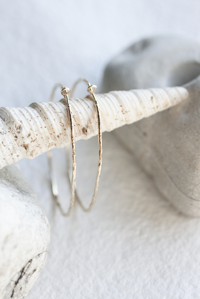 side view of gold textured hoop earrings