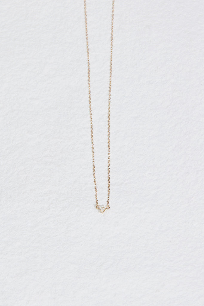 gold necklace with triangle white diamond