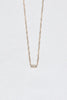 close up of gold cable chain necklace with 5 baguette diamonds