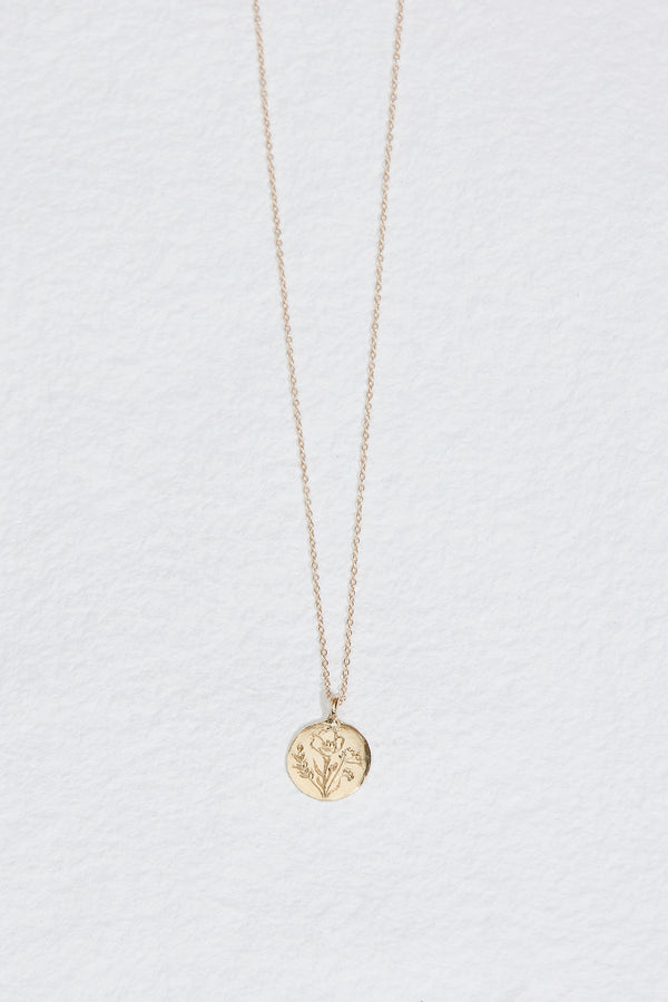 gold disc necklace with hand engraved flowers