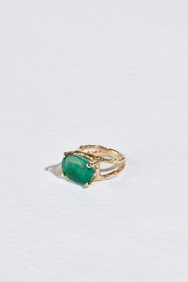 side view of gold textured double band with zambian emerald ring