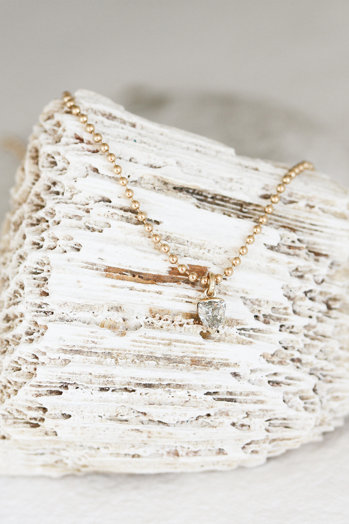 gold ball chain necklace with partial bezel set trillion salt and pepper diamond