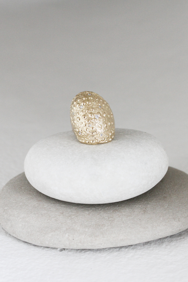 gold textured band with scattered round diamonds
