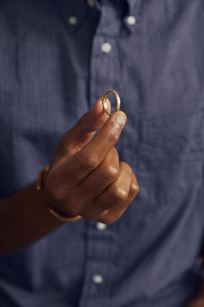 close up of man holding gold band
