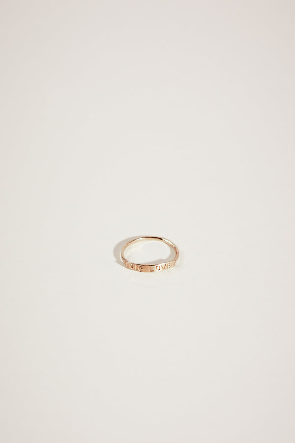 gold ring with "BIG LOVE" engraved plate