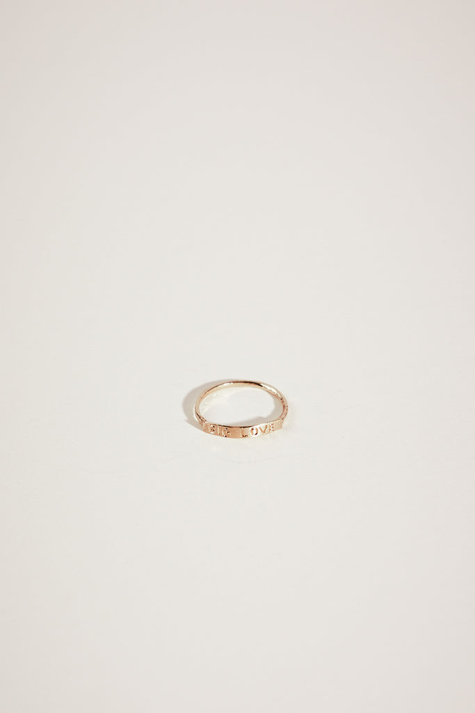 gold ring with "BIG LOVE" engraved plate