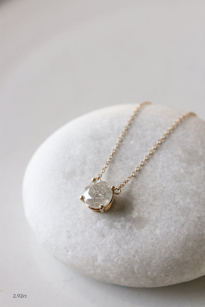 close up of 2.92ct gold necklace with round salt and pepper diamond