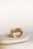 close up of gold 8 prong ring with rutilated quartz