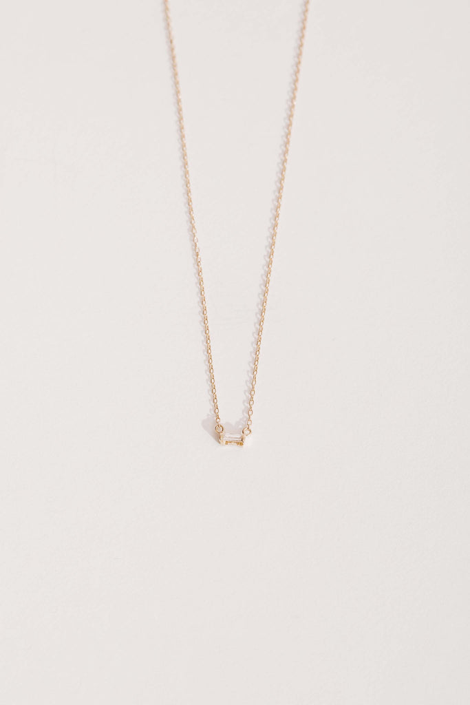 gold necklace with white diamond baguette