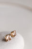 close up of gold cushion cut morganite stud earrings