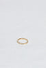 side view of yellow gold band with three baguette white diamonds