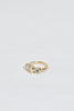 side view of gold ring with three bezel set round white diamonds