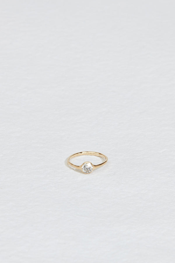 gold ring with bezel set round white diamond