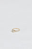 side view of gold ring with bezel set round white diamond