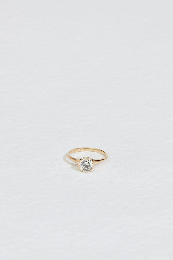 gold ring with bezel set round white diamond