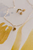 close up of gold cable chain necklace with gold tulip bud