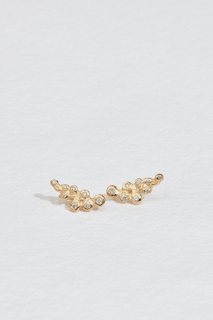 gold climber earrings with cluster of bezel set round white diamonds
