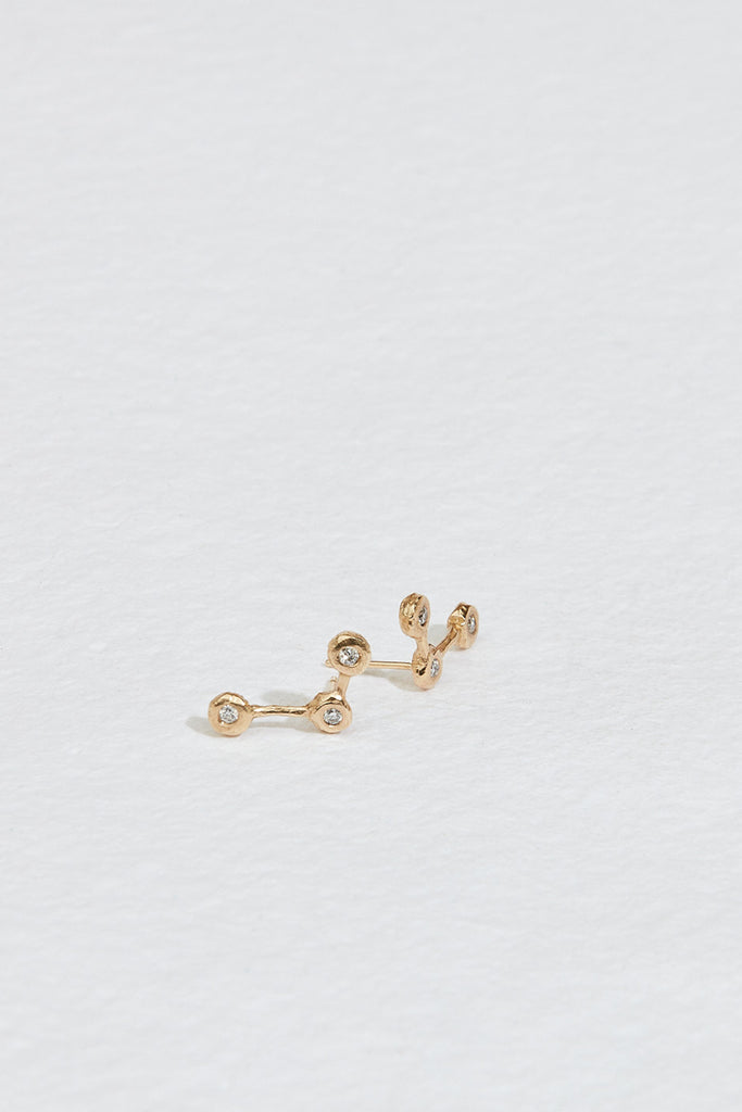 gold constellation inspired stud earrings with three round white diamonds