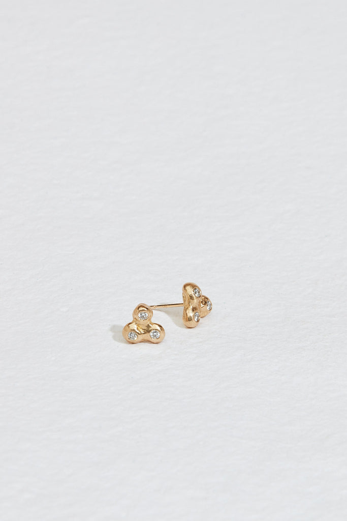 gold stud earrings with cluster of three bezel set round white diamonds