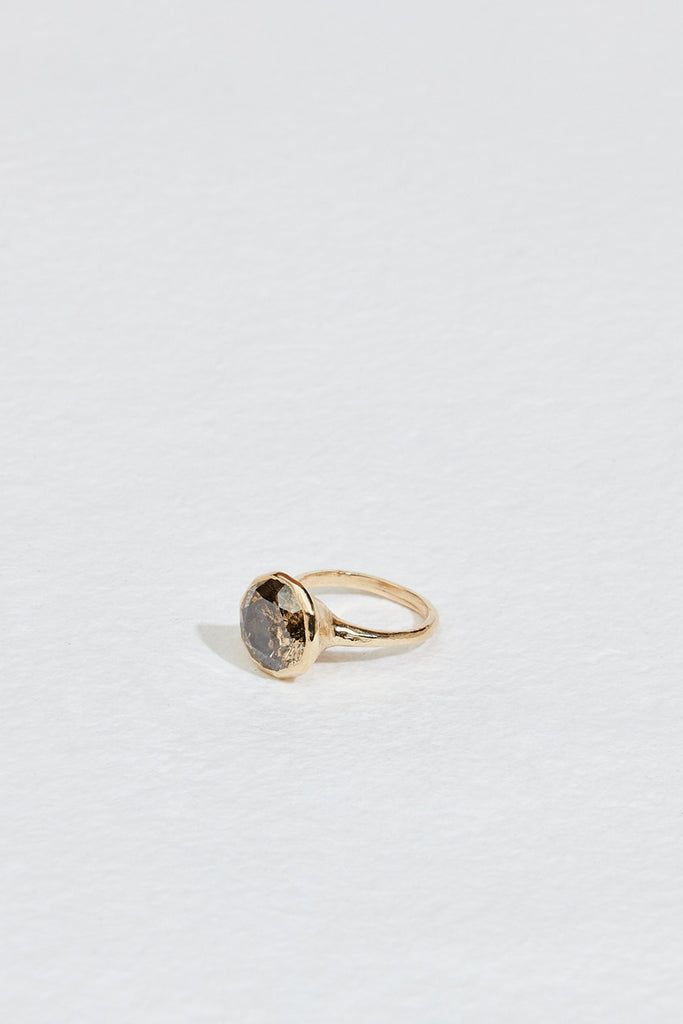side view of gold ring with decagon bezel set round mocha diamond