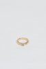 gold band with emerald cut champagne diamond and two round white diamonds