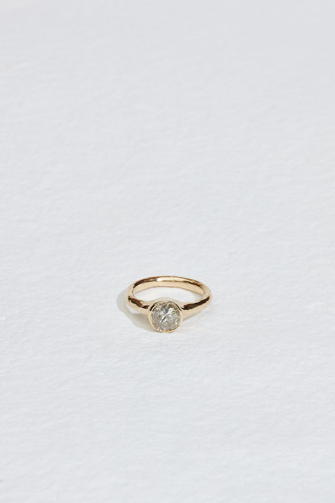 gold ring with bezel set round salt + pepper diamond