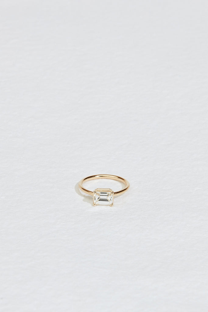 gold four prong emerald cut white diamond ring