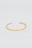 close up of gold flat cuff bracelet