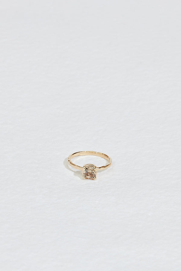 gold four prong ring with cushion cut light champagne diamond