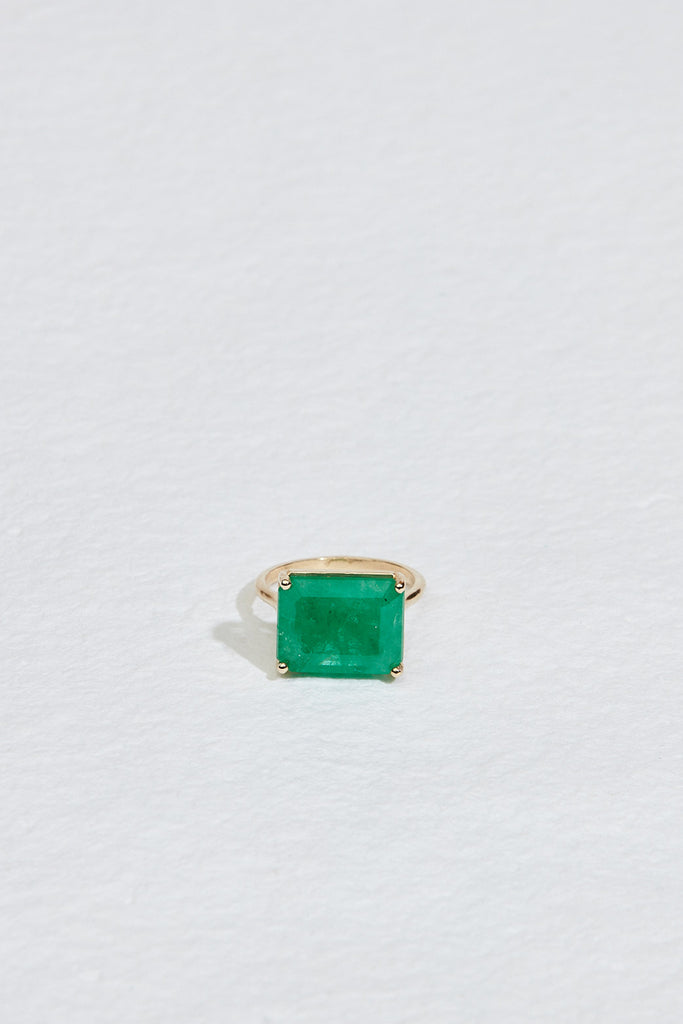 gold four prong ring with emerald cut emerald