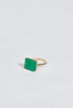 side view of gold four prong ring with emerald cut emerald