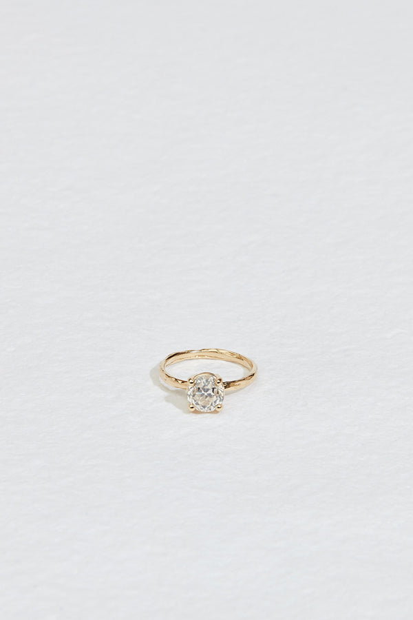gold four prong ring with old european cut round white diamond