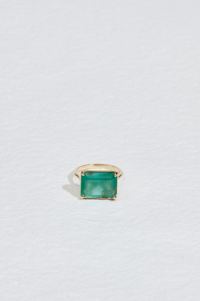 gold four prong ring with emerald cut zambian emerald