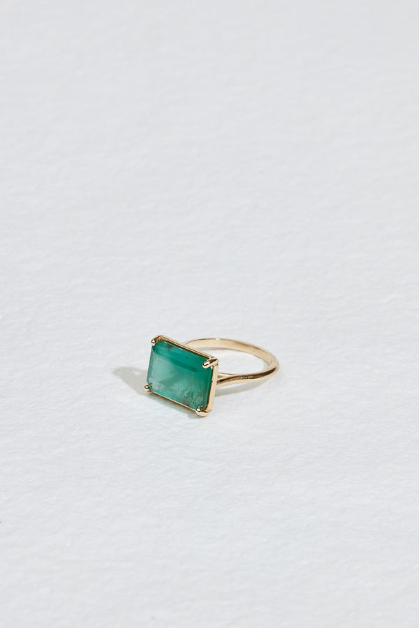 side view of gold four prong ring with emerald cut zambian emerald
