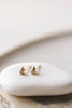 gold triangle earrings studded with bezel set round white diamond