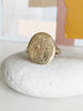 close up of gold signet ring with engraved flowers