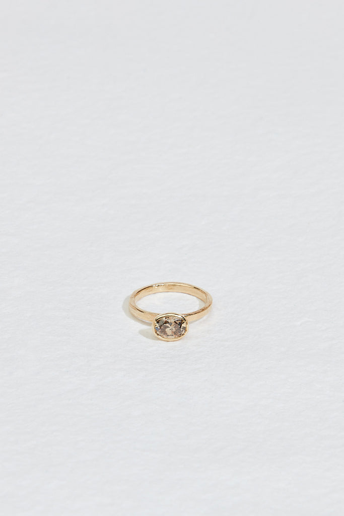 gold ring with bezel set oval champagne diamond