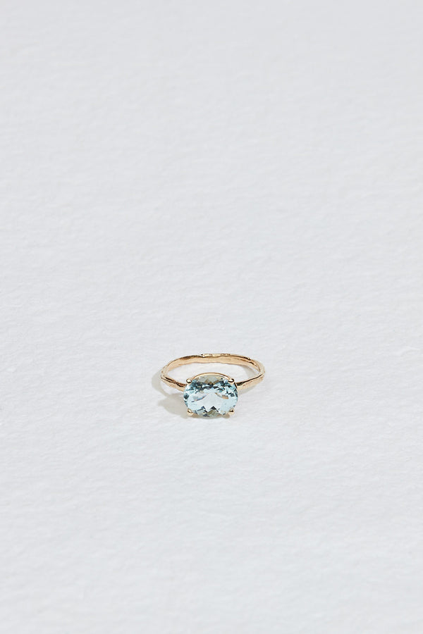 gold four prong oval aquamarine ring with textured band