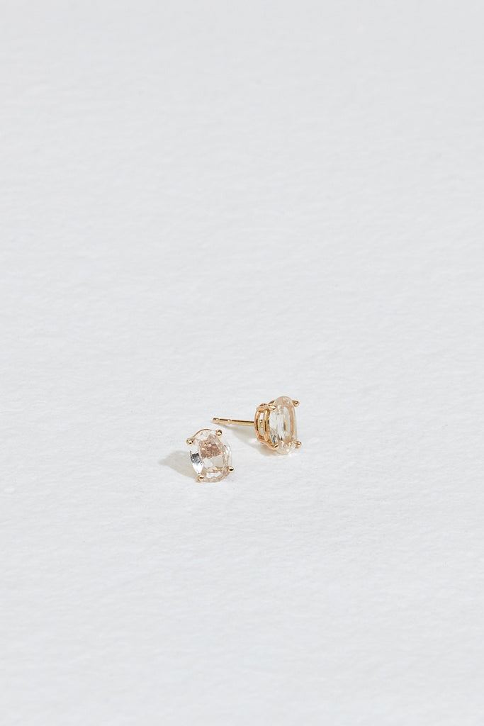gold oval peach sapphire studs with side view