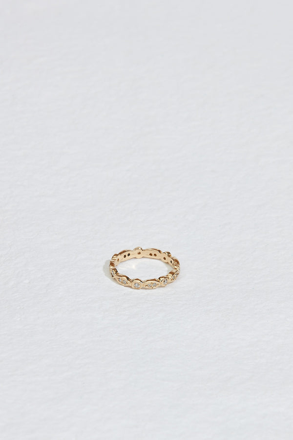 gold oval and circle bezel set eternity band with round white diamonds
