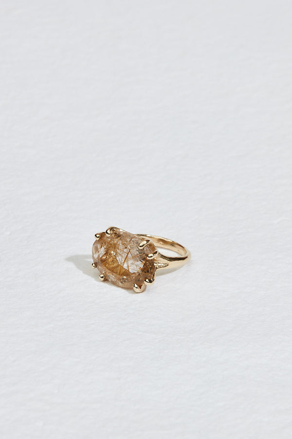 side view of gold 8 prong ring with rutilated quartz