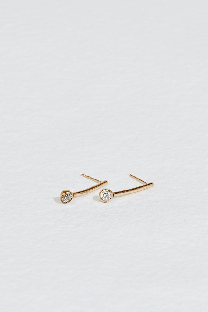 gold bar earrings with bezel set round white diamond