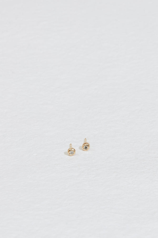 bezel set round white diamond stud earrings