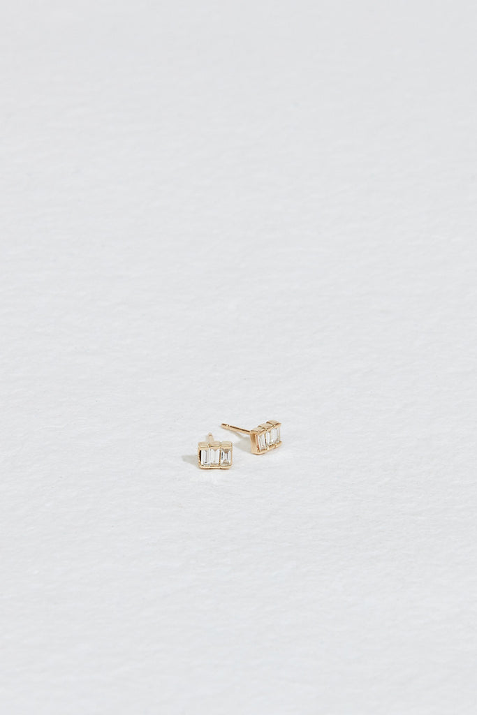 gold studs with three baguette white diamonds