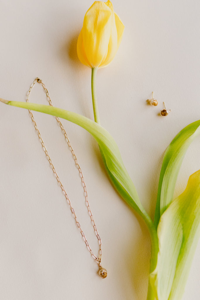 gold tulip bud studs alongside tulip and matching necklace